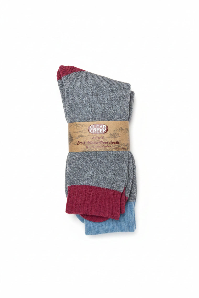 Three pairs of socks with a label on a textured surface